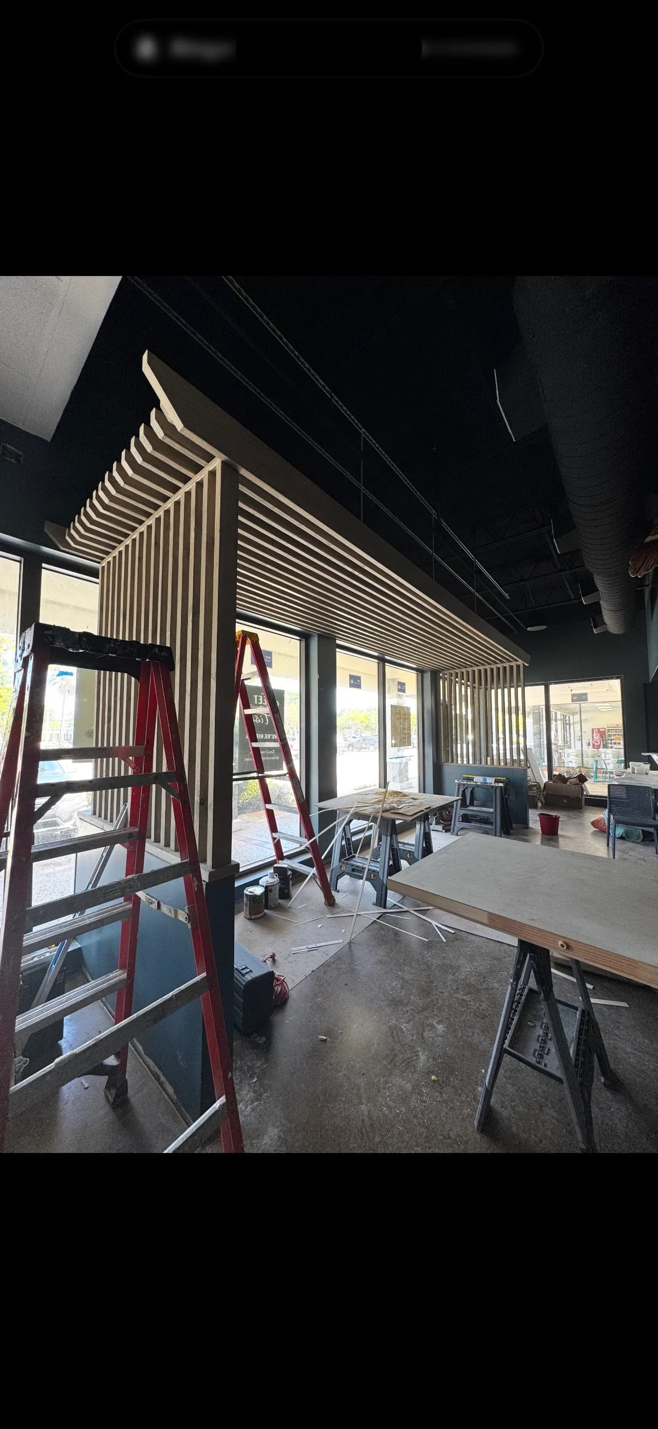 Sweet Fish dining area with wood slat details and large front windows during buildout.