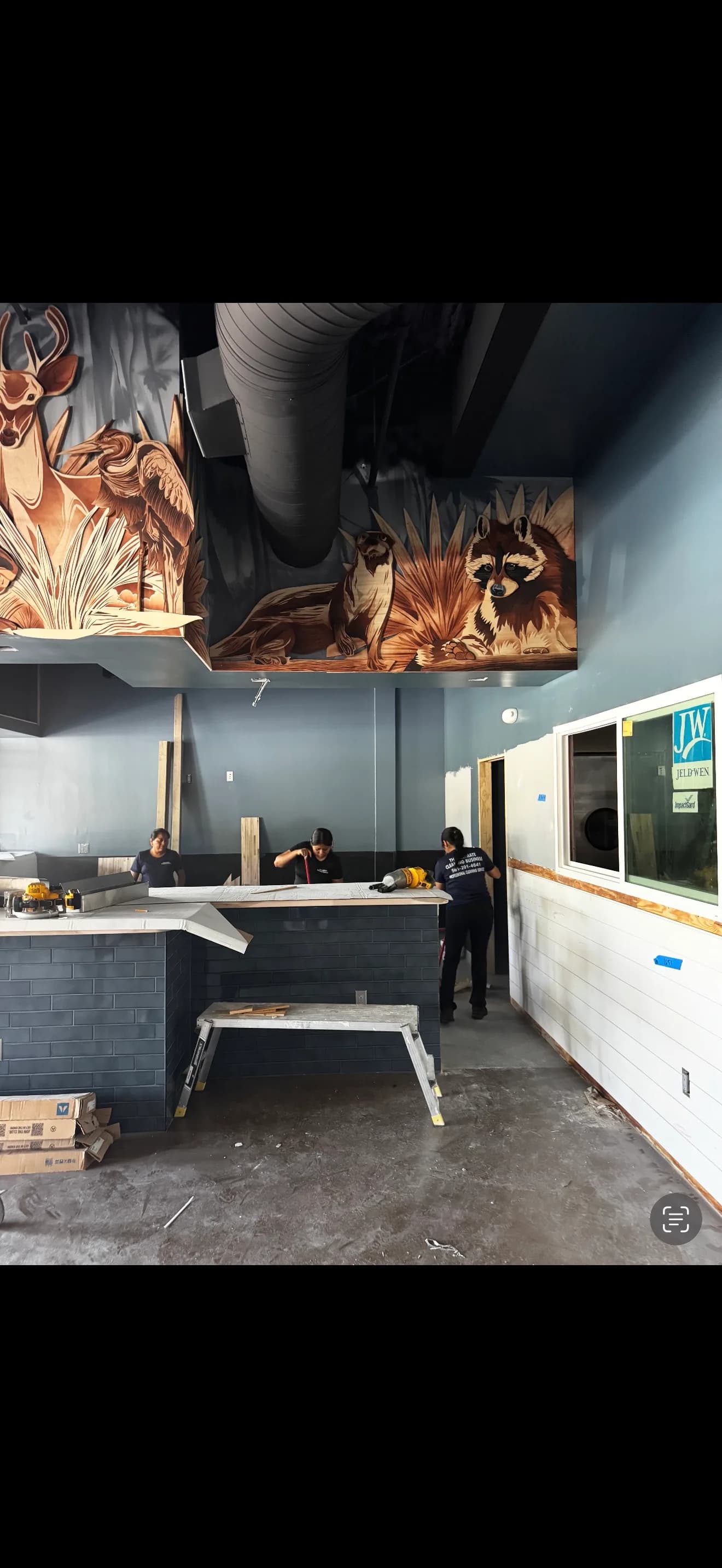 Sweet Fish dining room under construction with Florida wildlife artwork above the counter.