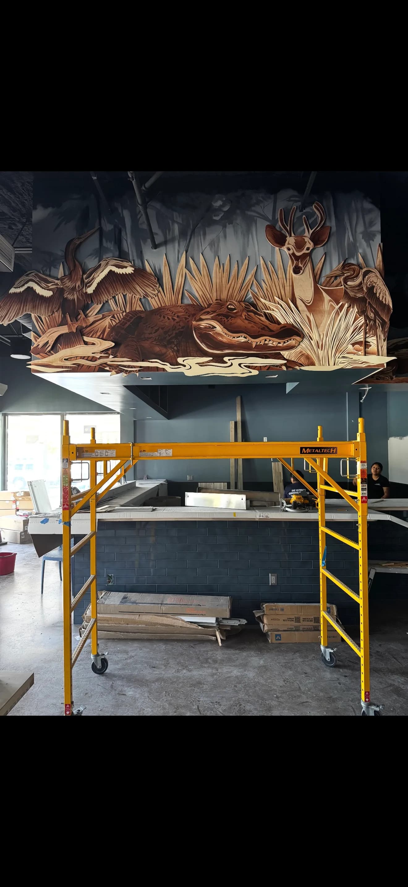 Sweet Fish interior buildout with a Florida wildlife mural above the counter.